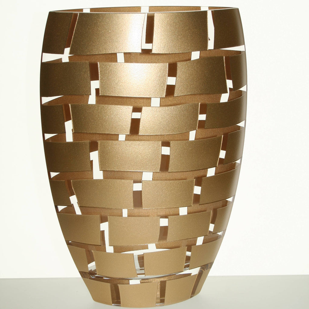 A modern metallic gold decorative vase with a woven, interlocking rectangular slat design, set against a plain white background.