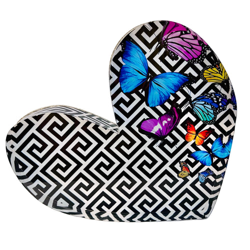 Acrylic heart-shaped block with a geometric pattern and colorful butterfly designs on it.