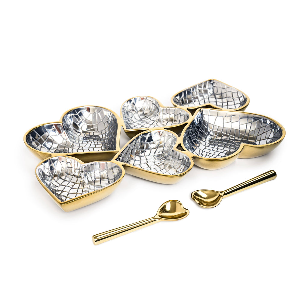 Set of heart-shaped dishes with mosaic patterns and gold edges, accompanied by matching spoons on a white background.