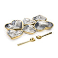 Set of heart-shaped dishes with mosaic patterns and gold edges, accompanied by matching spoons on a white background.