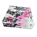 Decorative candy dish with floral and abstract patterns on a white background