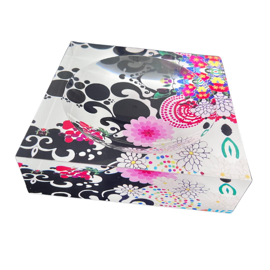 Decorative candy dish with floral and abstract patterns on a white background