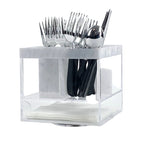 A clear plastic swivel silverware caddy with marble design accents, containing cutlery and a napkin holder.